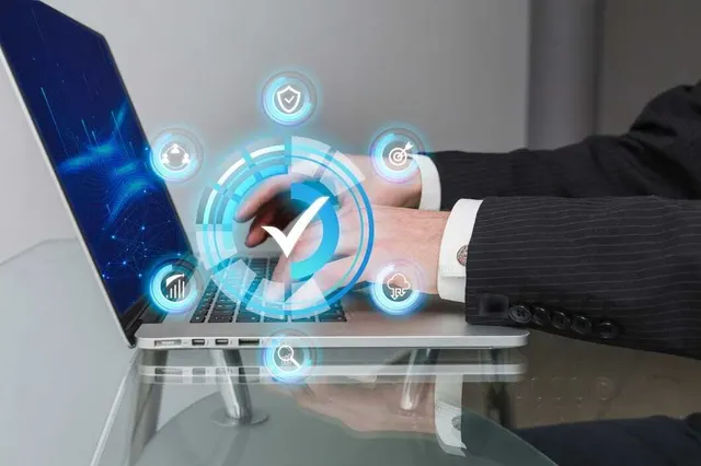 Professional using a laptop with relational database management icons for database design work