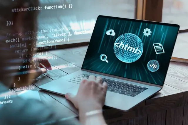 Developer coding a front-end web interface on a laptop with HTML and JavaScript overlays